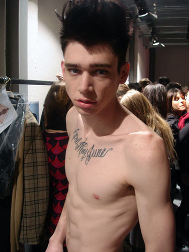 Model Cole Mohr Chest Calligraphy Tattoo